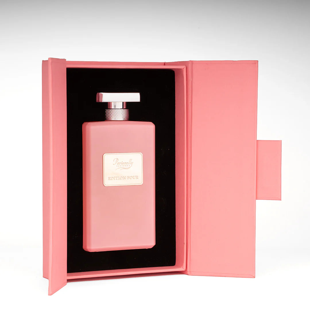 Pink perfume bottle in an open pink box on a white background