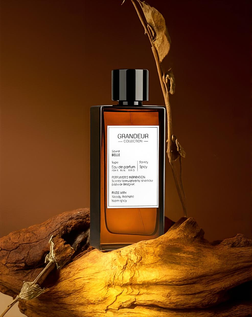 Perfume bottle labeled 'Grandeur' on a wooden surface with a warm brown background