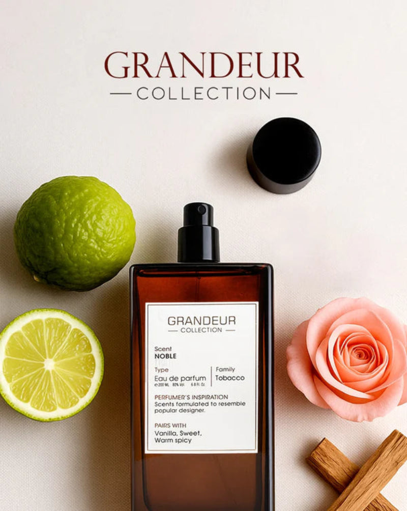 Grandeur Collection perfume bottle with lime, rose, and cinnamon on a light background