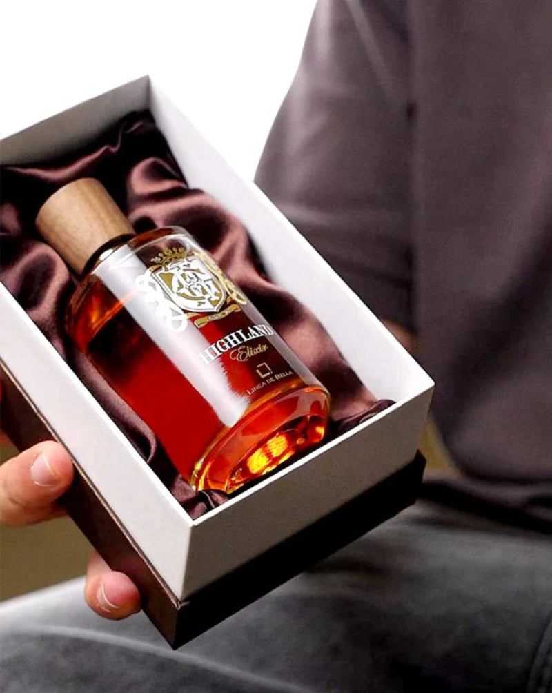 Bottle of Highland Club whisky in a gift box held by a person.