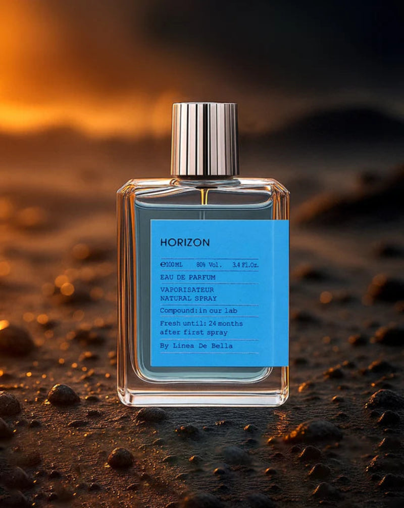 Perfume bottle labeled 'Horizon' on a textured surface with warm lighting