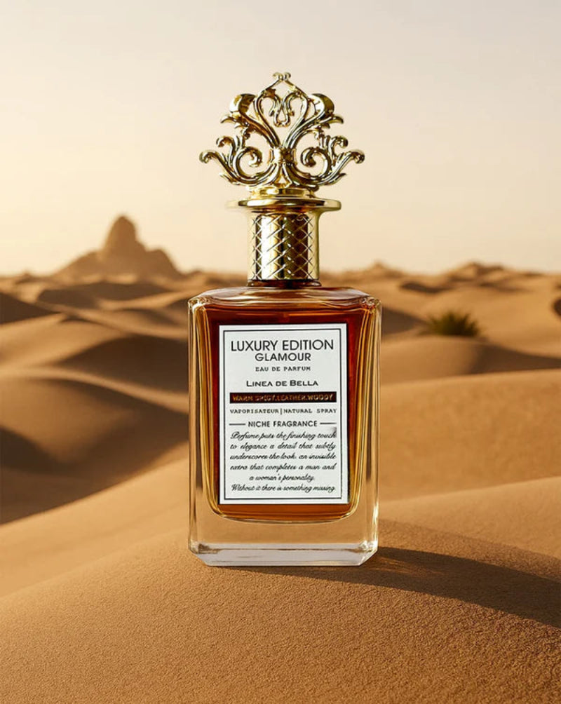 Perfume bottle with ornate design on sand dunes