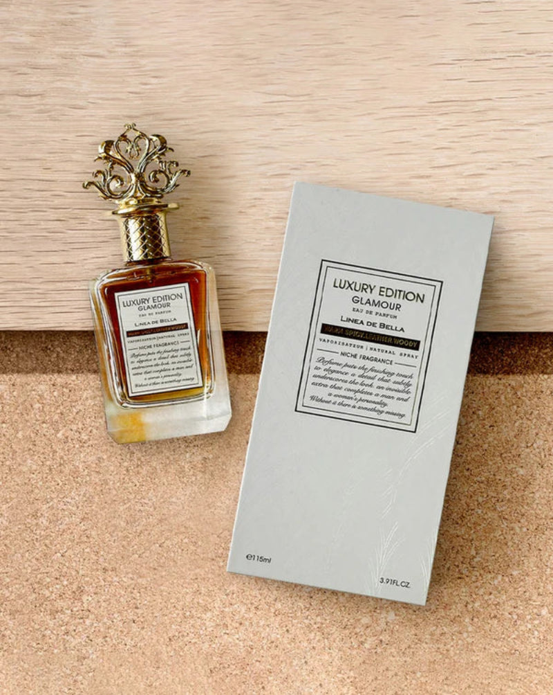 Perfume bottle with decorative cap and packaging on a wooden surface