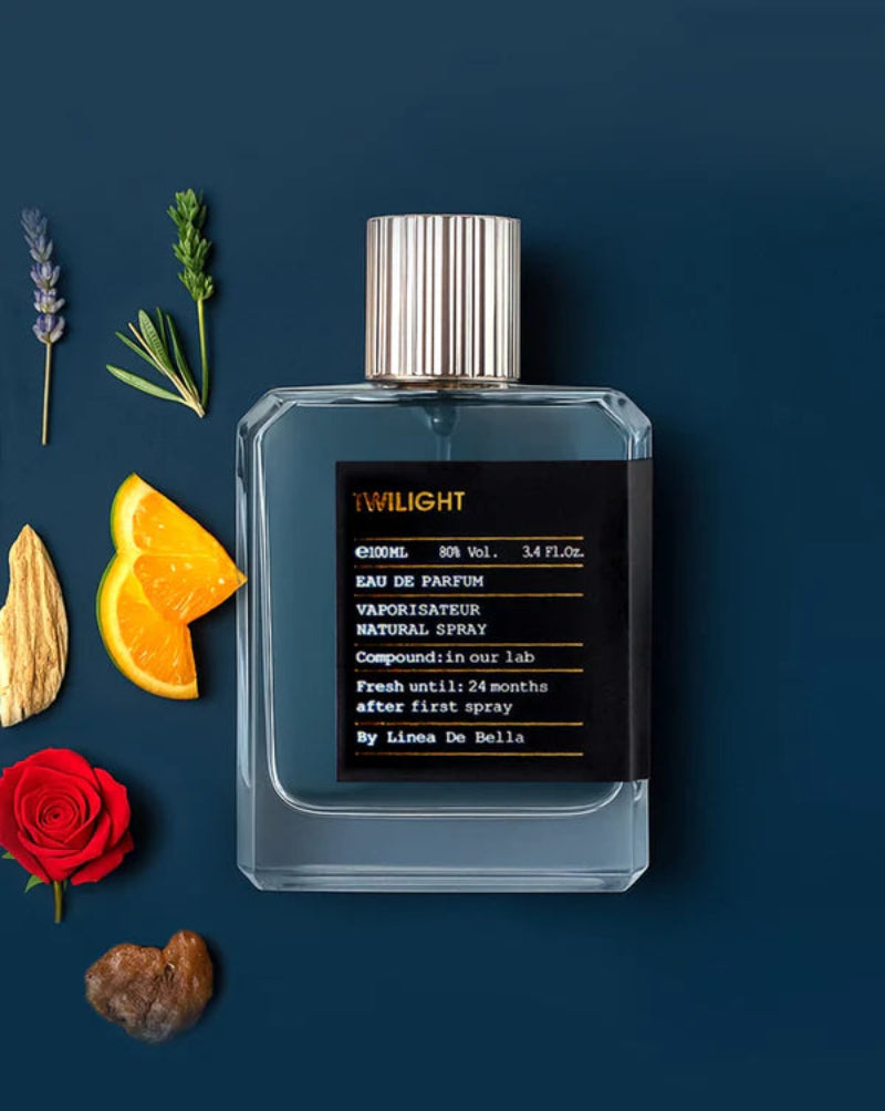 Perfume bottle labeled 'Twilight' with floral and fruit elements on a dark background