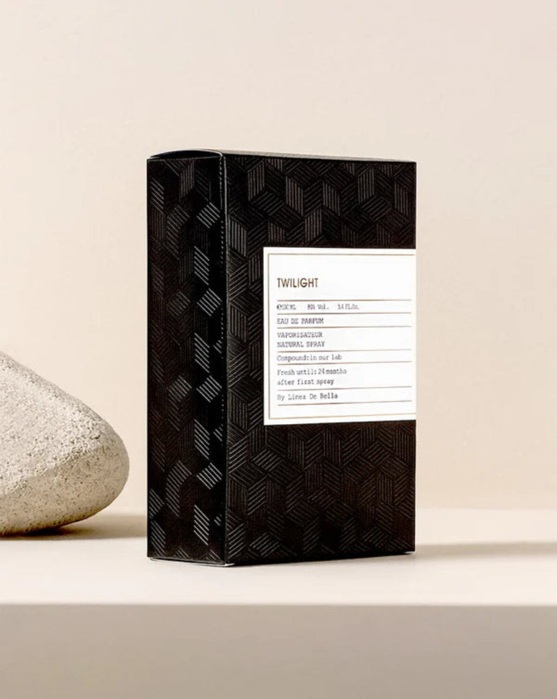 Black patterned box with a label on a beige background